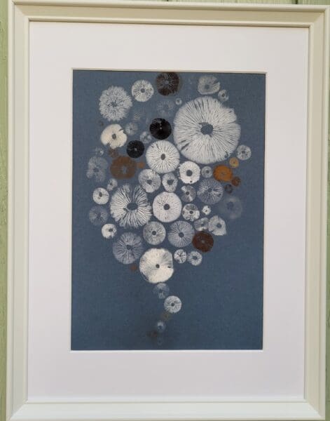 Mushroom spore print on blue in shape of a baloon