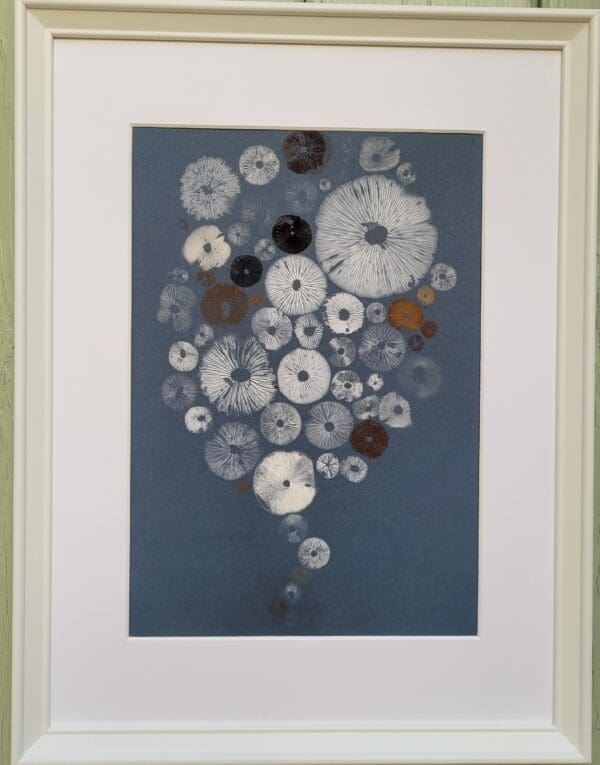 Mushroom spore print on blue in shape of a baloon