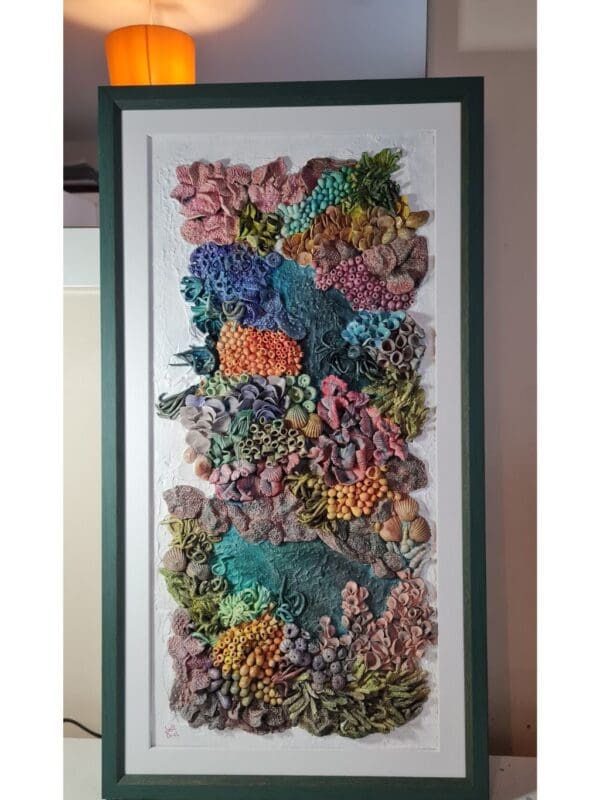 Thumbnail: clay textures in a variety of bold colours including purples, blues, greens, oranges, and pinks. Thumbnail: clay textures in a variety of bold colours including purples, blues, greens, oranges, and pinks. Thumbnail: clay textures in a variety of bold colours including purples, blues, greens, oranges, and pinks. Thumbnail: ange, purple, blue, and green, with highly detailed surface patterns and depth. Thumbnail: clay textures in a variety of bold colours including purples, blues, greens, oranges, and pinks. Thumbnail: clay textures in a variety of bold colours including purples, blues, greens, oranges, and pinks. Thumbnail: clay textures in a variety of bold colours including purples, blues, greens, oranges, and pinks. Original 3D Mixed Media Artwork – Air-Dry Clay, Acrylic, Varnish | Framed | For Sale Dive into a colourful underwater world with Kaleidoscope — a vibrant, textural artwork inspired by the rich beauty of coral reefs. Hand-sculpted from air-dry clay and painted in layers of acrylic, this piece bursts with playful shapes, bold colours, and ocean-inspired forms that seem to dance across the surface. Every detail is created by hand, bringing to life the organic variety of marine textures — from soft sea sponges and anemones to clusters of coral and imagined reef life. Finished with a protective varnish and professionally framed, it’s ready to brighten any space. Perfect for ocean lovers, collectors of unique art, or anyone drawn to tactile, nature-inspired creations. Kaleidoscope - 3D textured mixed media wall art
