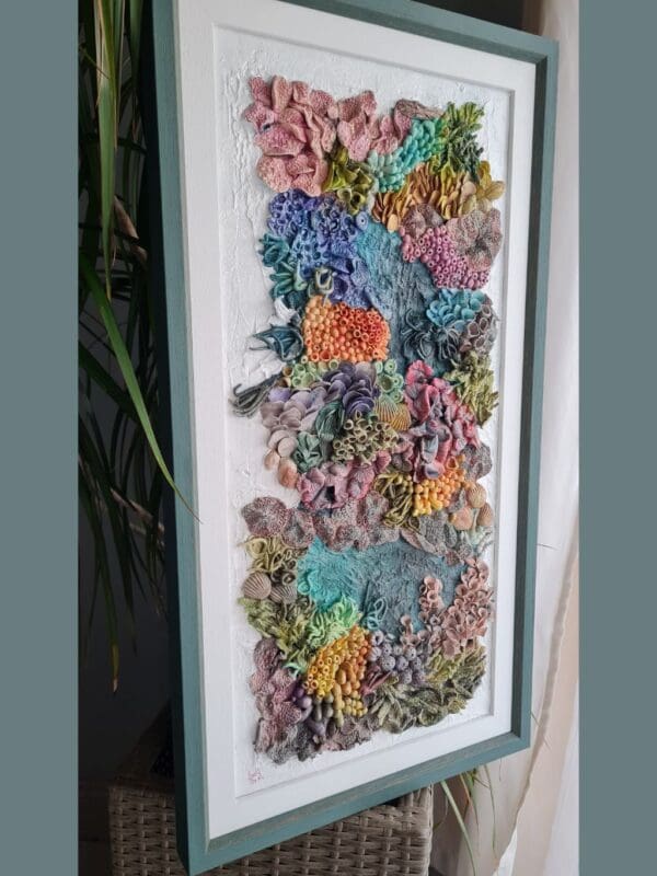 Thumbnail: clay textures in a variety of bold colours including purples, blues, greens, oranges, and pinks. Thumbnail: clay textures in a variety of bold colours including purples, blues, greens, oranges, and pinks. Thumbnail: clay textures in a variety of bold colours including purples, blues, greens, oranges, and pinks. Thumbnail: ange, purple, blue, and green, with highly detailed surface patterns and depth. Thumbnail: clay textures in a variety of bold colours including purples, blues, greens, oranges, and pinks. Thumbnail: clay textures in a variety of bold colours including purples, blues, greens, oranges, and pinks. Thumbnail: clay textures in a variety of bold colours including purples, blues, greens, oranges, and pinks. Original 3D Mixed Media Artwork – Air-Dry Clay, Acrylic, Varnish | Framed | For Sale Dive into a colourful underwater world with Kaleidoscope — a vibrant, textural artwork inspired by the rich beauty of coral reefs. Hand-sculpted from air-dry clay and painted in layers of acrylic, this piece bursts with playful shapes, bold colours, and ocean-inspired forms that seem to dance across the surface. Every detail is created by hand, bringing to life the organic variety of marine textures — from soft sea sponges and anemones to clusters of coral and imagined reef life. Finished with a protective varnish and professionally framed, it’s ready to brighten any space. Perfect for ocean lovers, collectors of unique art, or anyone drawn to tactile, nature-inspired creations. Kaleidoscope - 3D textured mixed media wall art
