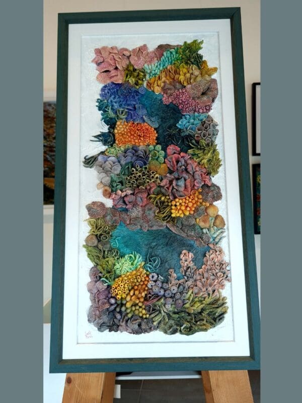 Thumbnail: clay textures in a variety of bold colours including purples, blues, greens, oranges, and pinks. Thumbnail: clay textures in a variety of bold colours including purples, blues, greens, oranges, and pinks. Thumbnail: clay textures in a variety of bold colours including purples, blues, greens, oranges, and pinks. Thumbnail: ange, purple, blue, and green, with highly detailed surface patterns and depth. Thumbnail: clay textures in a variety of bold colours including purples, blues, greens, oranges, and pinks. Thumbnail: clay textures in a variety of bold colours including purples, blues, greens, oranges, and pinks. Thumbnail: clay textures in a variety of bold colours including purples, blues, greens, oranges, and pinks. Original 3D Mixed Media Artwork – Air-Dry Clay, Acrylic, Varnish | Framed | For Sale Dive into a colourful underwater world with Kaleidoscope — a vibrant, textural artwork inspired by the rich beauty of coral reefs. Hand-sculpted from air-dry clay and painted in layers of acrylic, this piece bursts with playful shapes, bold colours, and ocean-inspired forms that seem to dance across the surface. Every detail is created by hand, bringing to life the organic variety of marine textures — from soft sea sponges and anemones to clusters of coral and imagined reef life. Finished with a protective varnish and professionally framed, it’s ready to brighten any space. Perfect for ocean lovers, collectors of unique art, or anyone drawn to tactile, nature-inspired creations. Kaleidoscope - 3D textured mixed media wall art