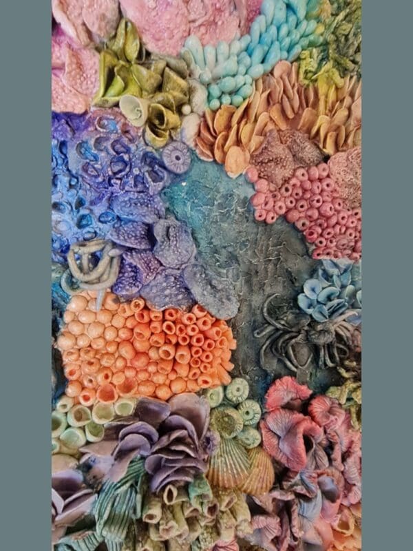 Thumbnail: clay textures in a variety of bold colours including purples, blues, greens, oranges, and pinks. Thumbnail: clay textures in a variety of bold colours including purples, blues, greens, oranges, and pinks. Thumbnail: clay textures in a variety of bold colours including purples, blues, greens, oranges, and pinks. Thumbnail: ange, purple, blue, and green, with highly detailed surface patterns and depth. Thumbnail: clay textures in a variety of bold colours including purples, blues, greens, oranges, and pinks. Thumbnail: clay textures in a variety of bold colours including purples, blues, greens, oranges, and pinks. Thumbnail: clay textures in a variety of bold colours including purples, blues, greens, oranges, and pinks. Original 3D Mixed Media Artwork – Air-Dry Clay, Acrylic, Varnish | Framed | For Sale Dive into a colourful underwater world with Kaleidoscope — a vibrant, textural artwork inspired by the rich beauty of coral reefs. Hand-sculpted from air-dry clay and painted in layers of acrylic, this piece bursts with playful shapes, bold colours, and ocean-inspired forms that seem to dance across the surface. Every detail is created by hand, bringing to life the organic variety of marine textures — from soft sea sponges and anemones to clusters of coral and imagined reef life. Finished with a protective varnish and professionally framed, it’s ready to brighten any space. Perfect for ocean lovers, collectors of unique art, or anyone drawn to tactile, nature-inspired creations. Kaleidoscope - 3D textured mixed media wall art