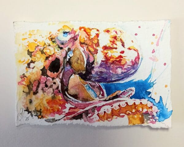 Watercolour painting of a vibrant coloured octopus. Showng its head and some of its tentacle. The paper has hand torn edges and it is float mounted in a black deep edged frame