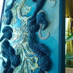 Textured mixed media artwork with hand-sculpted fish shapes in layered blue acrylic tones, surrounded by repeated dark blue sculptural forms, presented in a custom dark blue frame.