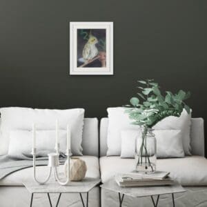 Parrot sitting on perch framed and hanging on a wall