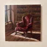 Sunlight, old books and a chair, quietly carrying the absence of someone once there.