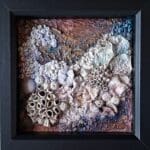 Framed mixed‑media coral artwork “Corals 1” with textured sea‑inspired design in purple and copper tones.
