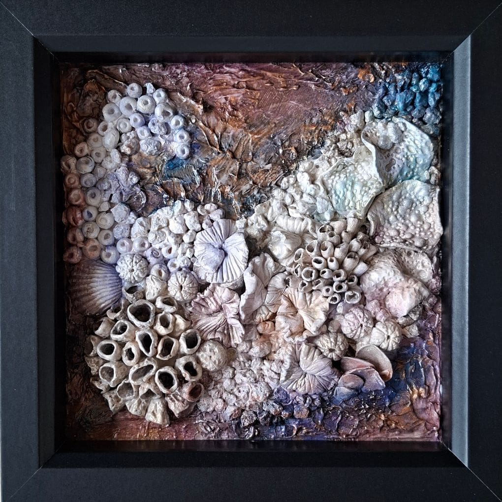 Framed mixed‑media coral artwork “Corals 1” with textured sea‑inspired design in purple and copper tones.