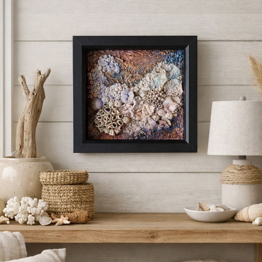 Framed coral artwork displayed in coastal home setting with driftwood and seashell décor.