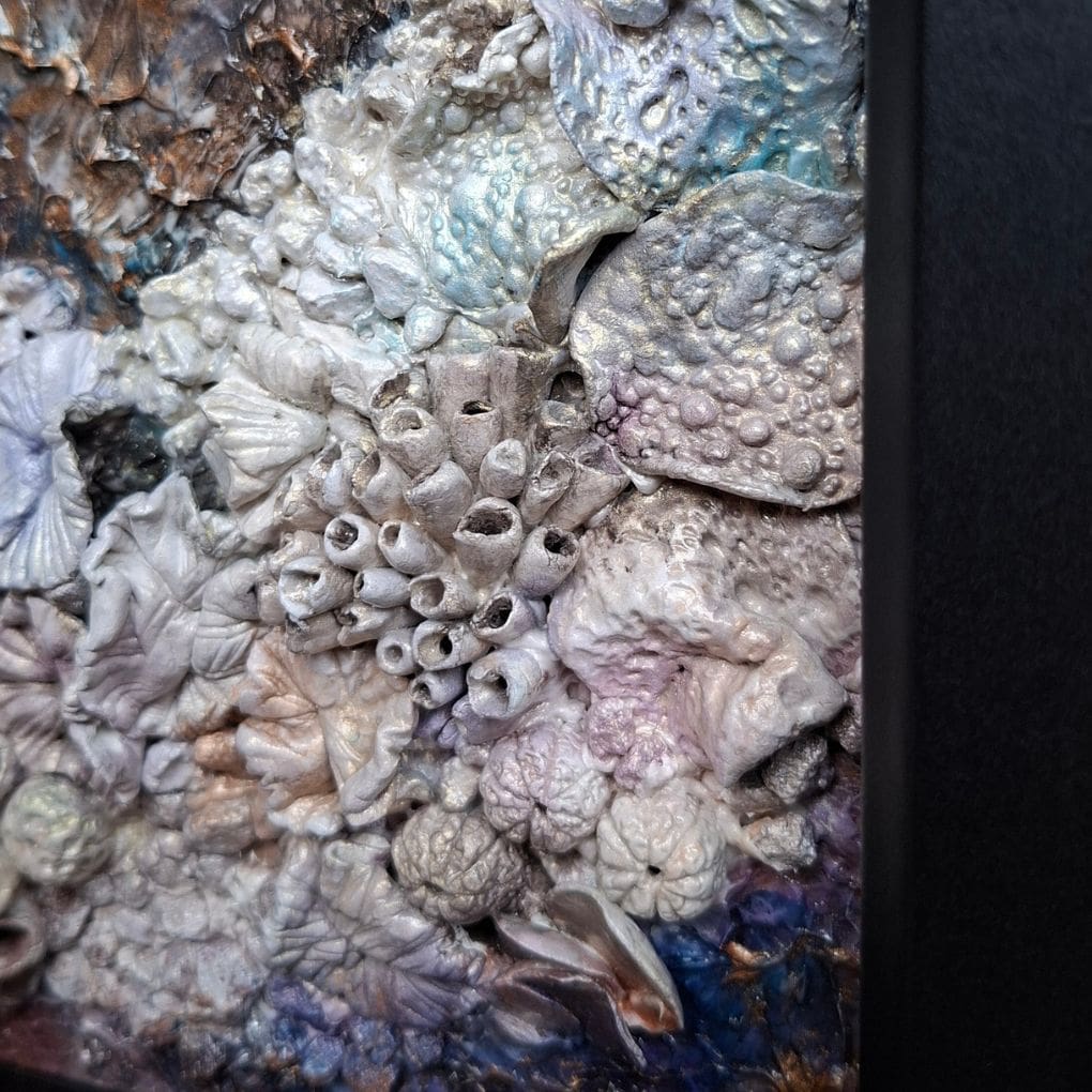 Intricate sculpted coral and shell textures with gold accents in ocean‑inspired artwork.