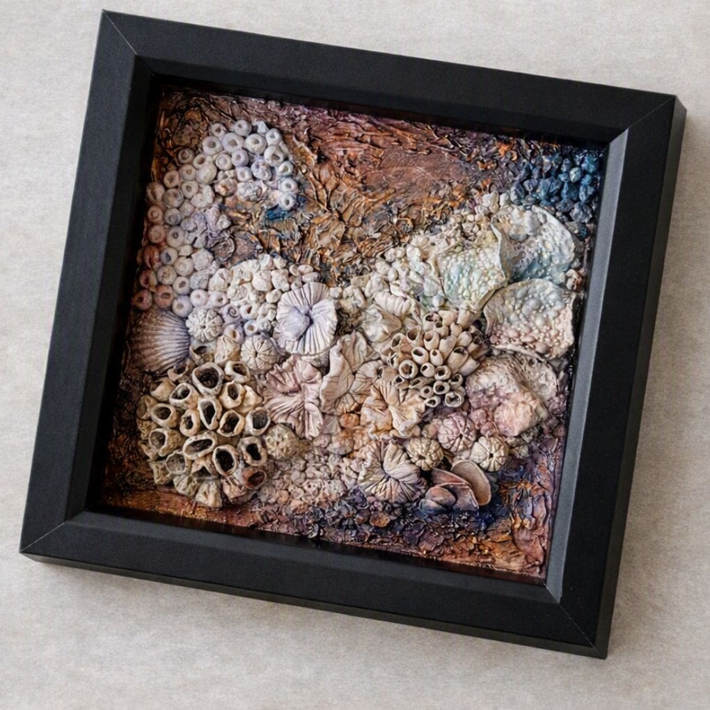 Detailed close‑up of coral formations with gold shimmer and purple highlights in mixed‑media artwork.