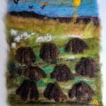 Needle-felted artwork depicting an Irish bog landscape in summer, with turf banks, earthy tones, and soft green vegetation beneath a warm sky.