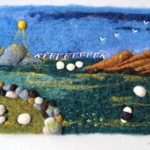 Nestled between the hills, sheep graze among fields divided by old stone walls. Needle felted using carded wool from Kerry Woollen Mills.