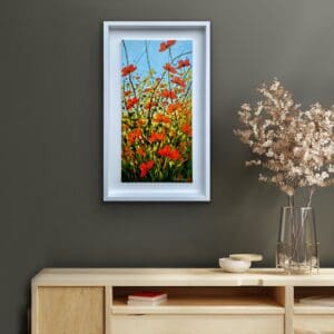 Our Gift poppy painting displayed above a console table in a cosy room