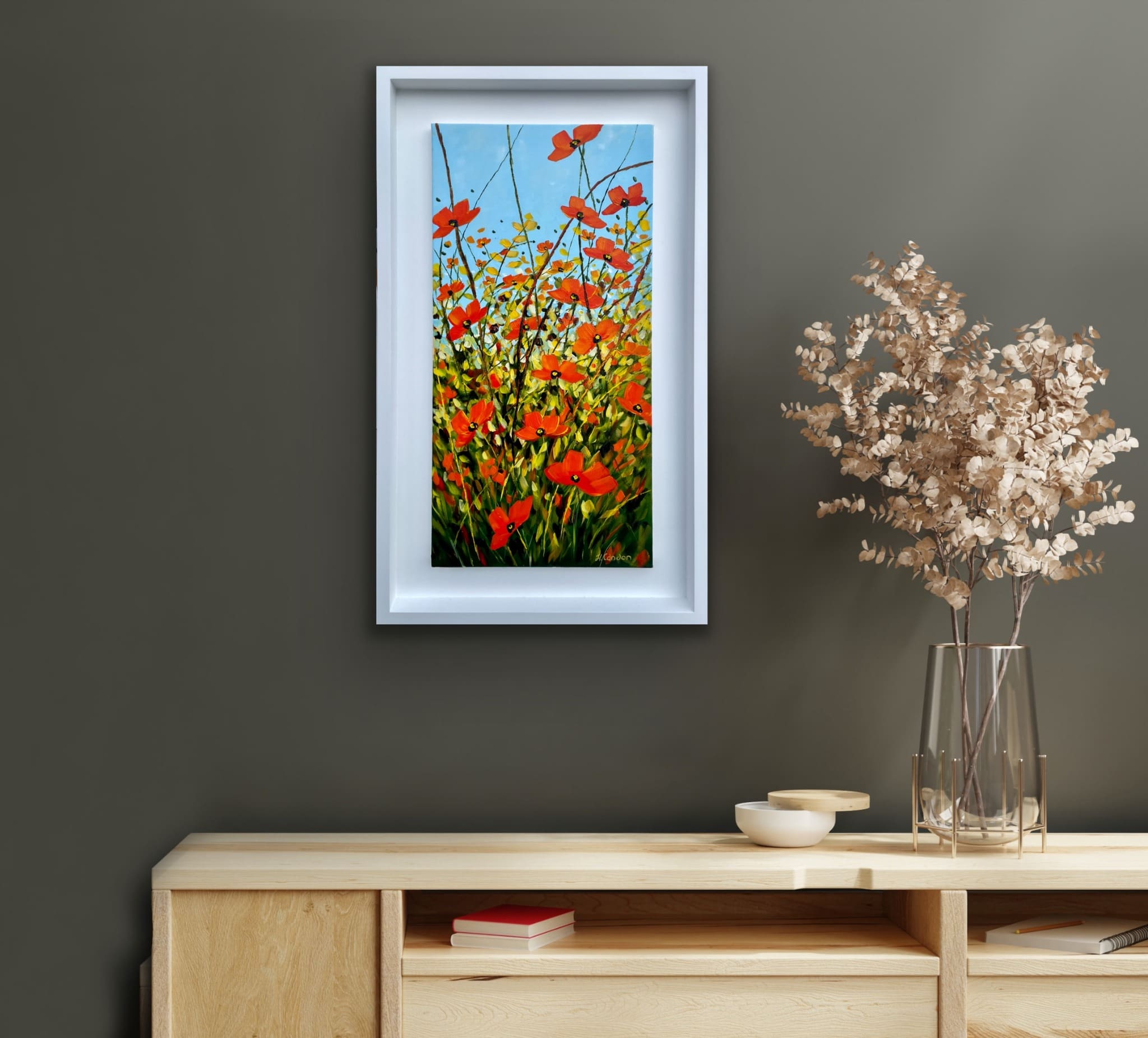 Our Gift poppy painting displayed above a console table in a cosy room